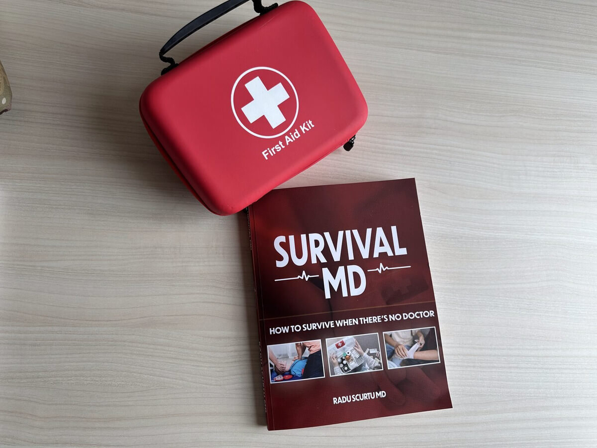 Survival MD open on the floor next to a first aid kit during an emergency