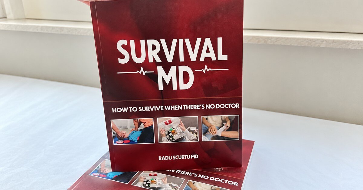 A hand lifting a copy of Survival MD by Dr. Radu Scurtu from a second copy beside a window