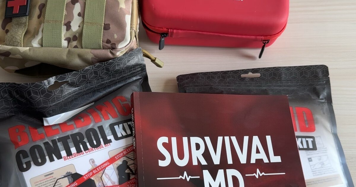 The Survival MD book by Dr. Radu Scurtu with a bleeding control kit, a trauma pouch and a first aid kit